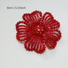 A vibrant red crystal rhinestone flower sew-on patch with intricate petal design.