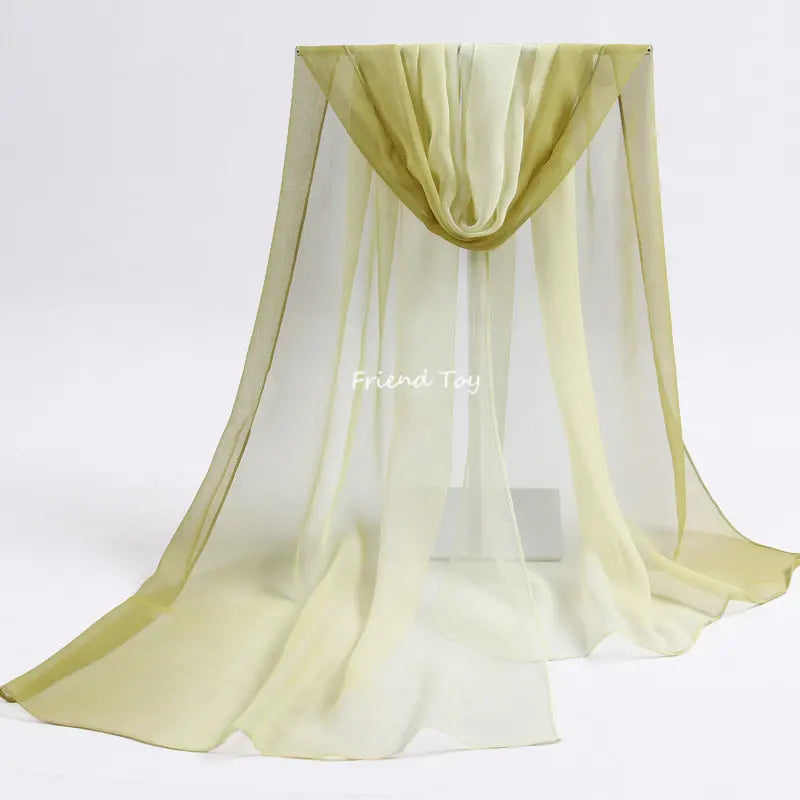 Sheer, pale yellow fabric playsilk draped in a flowing, gathered style for imaginative play.