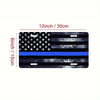 A black and gray metal sign depicting the American flag with a blue stripe, measuring 12 inches by 6 inches.