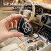 Black non-slip waterproof car cup holder coasters with a camellia paw pattern being held in a hand.