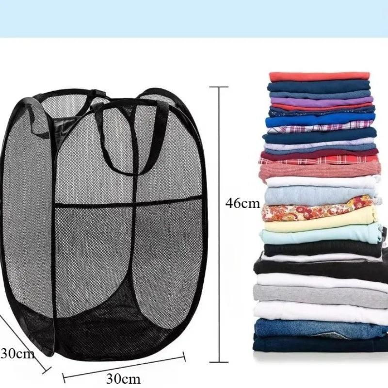 Black foldable mesh laundry basket with handles shown next to a stack of folded clothes.