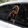 A close-up view of a brown horse silhouette decal applied to the side window of a white car.