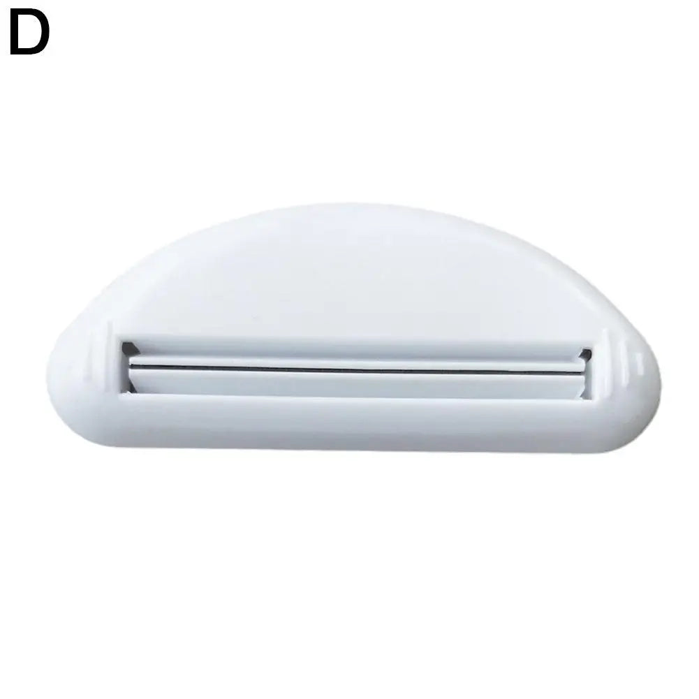 A white manual tube squeezer for toiletries with a flat, oval design.
