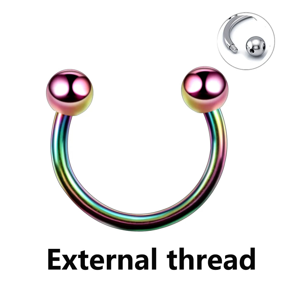 A polished titanium horseshoe septum ring with a smooth, iridescent finish and an attached ball.