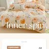 A beige and orange floral bedding set featuring a duvet cover, fitted sheet, and pillows on a bed.