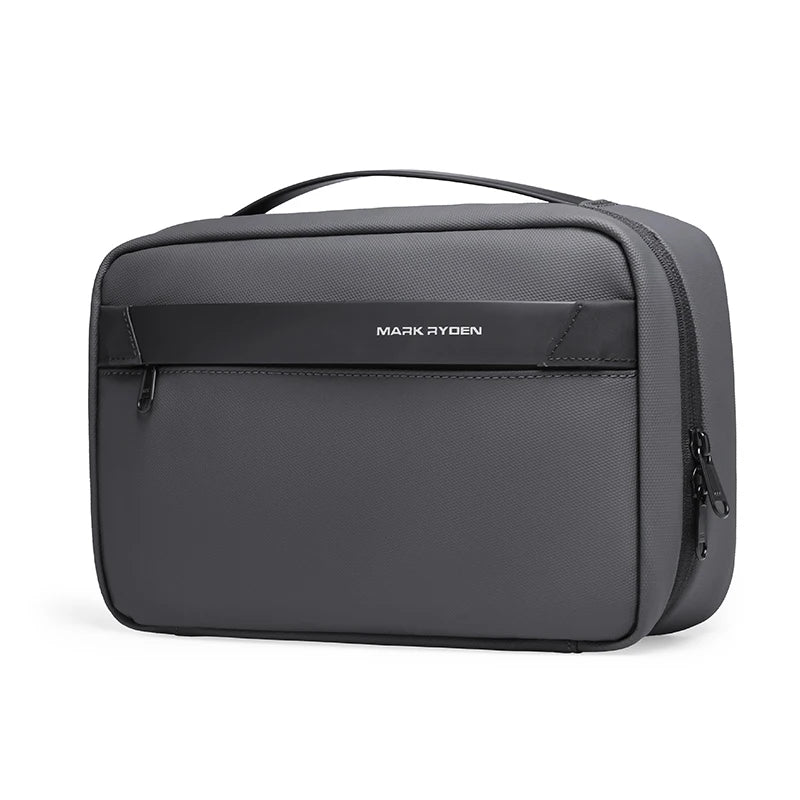 A dark gray waterproof travel toiletry bag with a handle and a logo on the front.