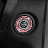 Close-up of a black car button featuring a circular crystal rhinestone start and stop mechanism.