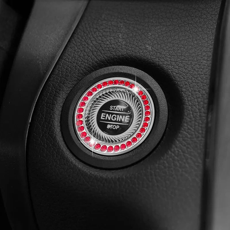 Close-up of a black car button featuring a circular crystal rhinestone start and stop mechanism.