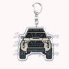 A silver metal keychain featuring a detailed silhouette of an off-road truck.