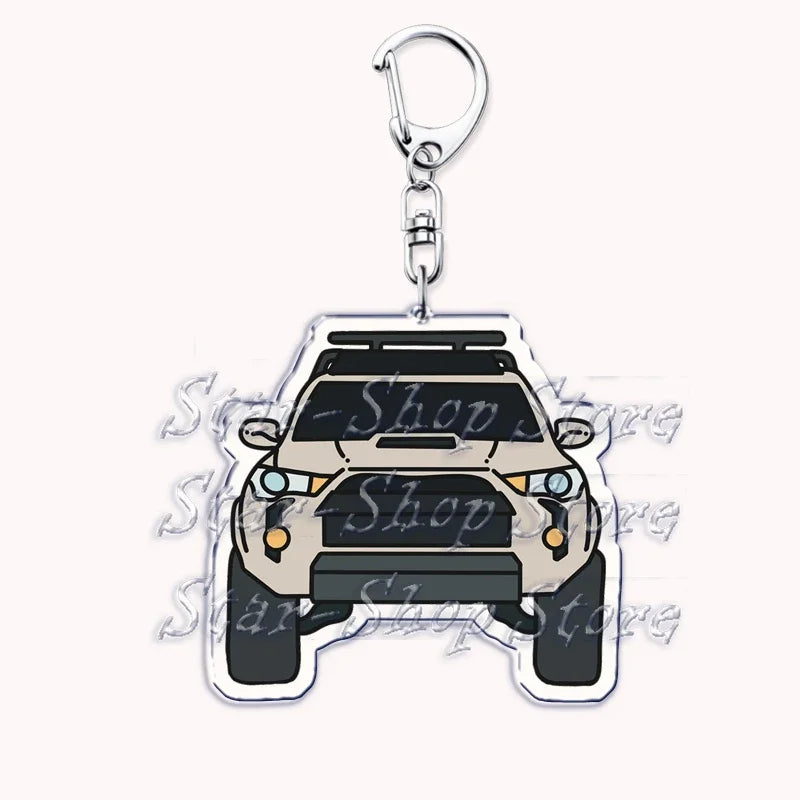 A silver metal keychain featuring a detailed silhouette of an off-road truck.