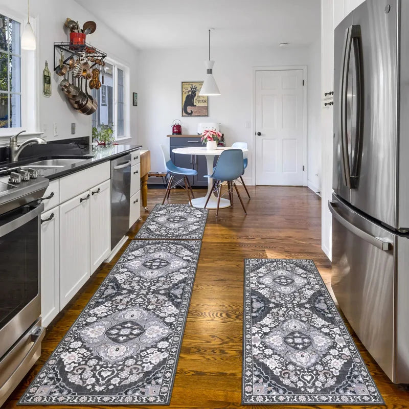 A long, patterned gray and white kitchen rug lies on a wooden floor in a bright room.