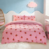 Pink strawberry print duvet cover set with matching pillowcases displayed on a white bed.