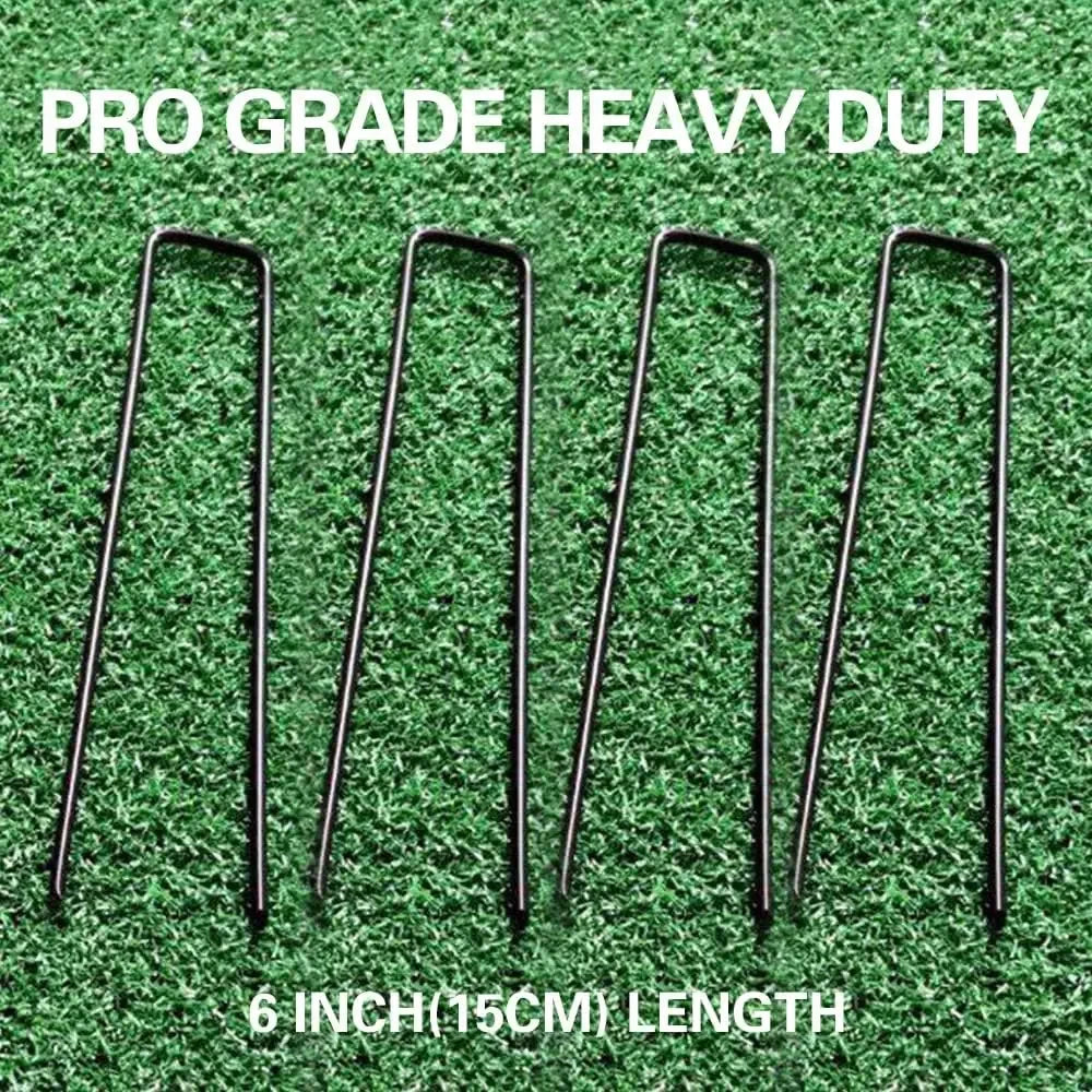 Six 6 inch galvanized U-shaped garden staples displayed on green artificial turf.