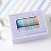 A box of solid color tape with 20 rolls of various pastel colors for crafting and journaling.