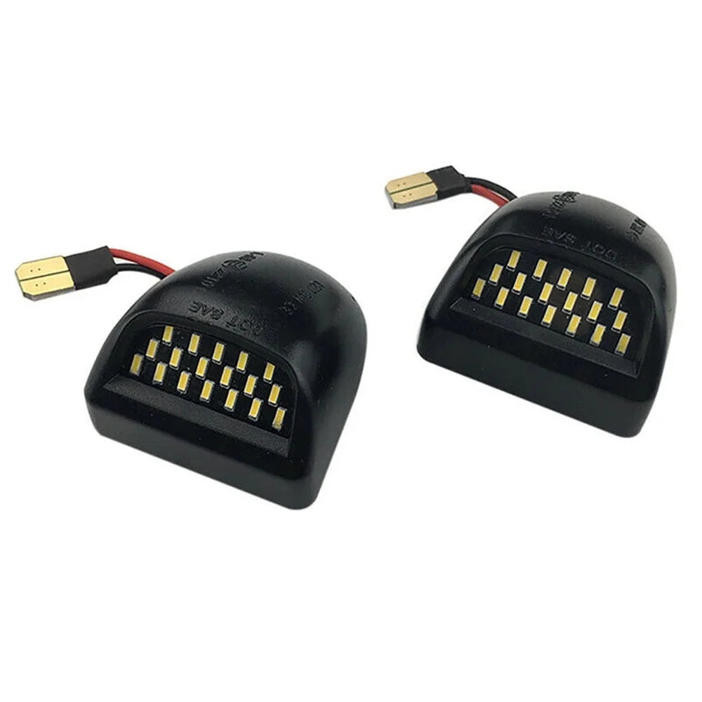 Black LED license plate light module with wiring for Chevy Silverado and GMC Sierra trucks
