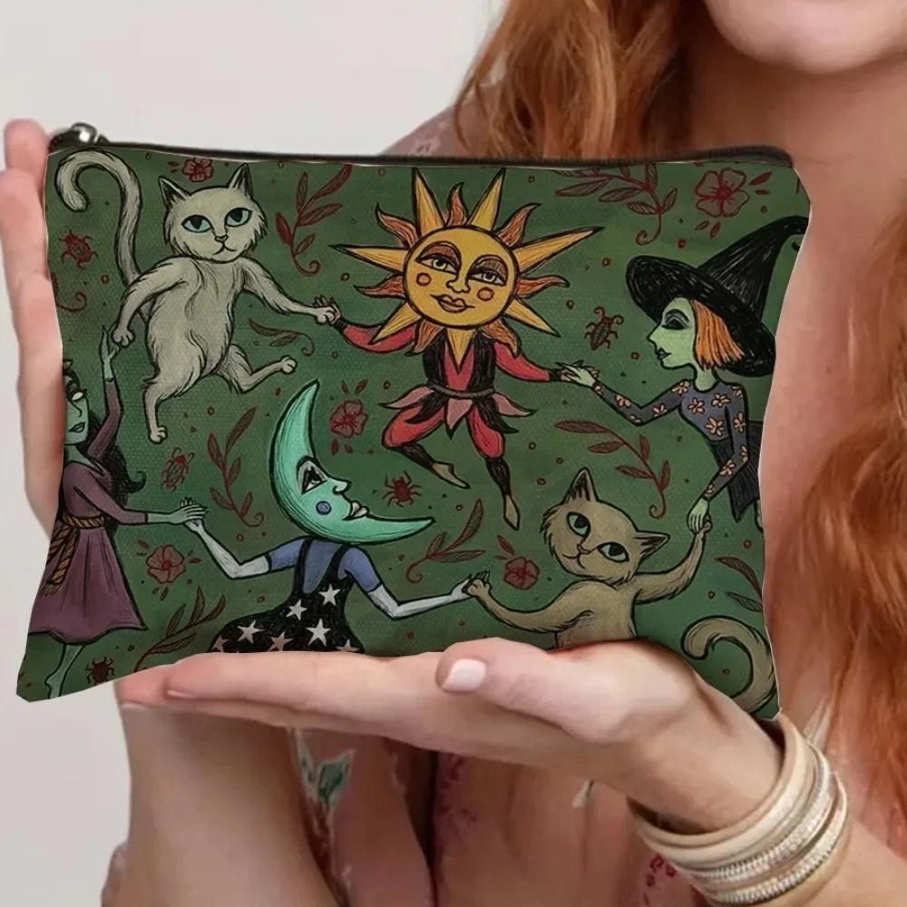 A green canvas storage pouch featuring illustrations of cats and a witch