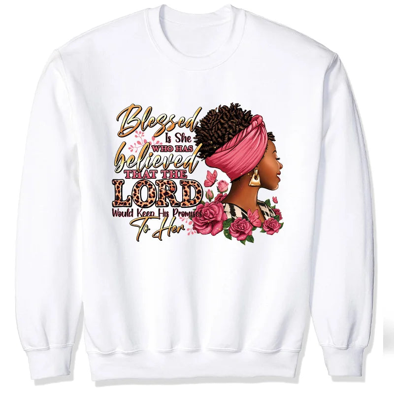 White sweatshirt featuring a graphic design with pink flowers and text that reads Blessed Is She Who Has Believed That The Lo