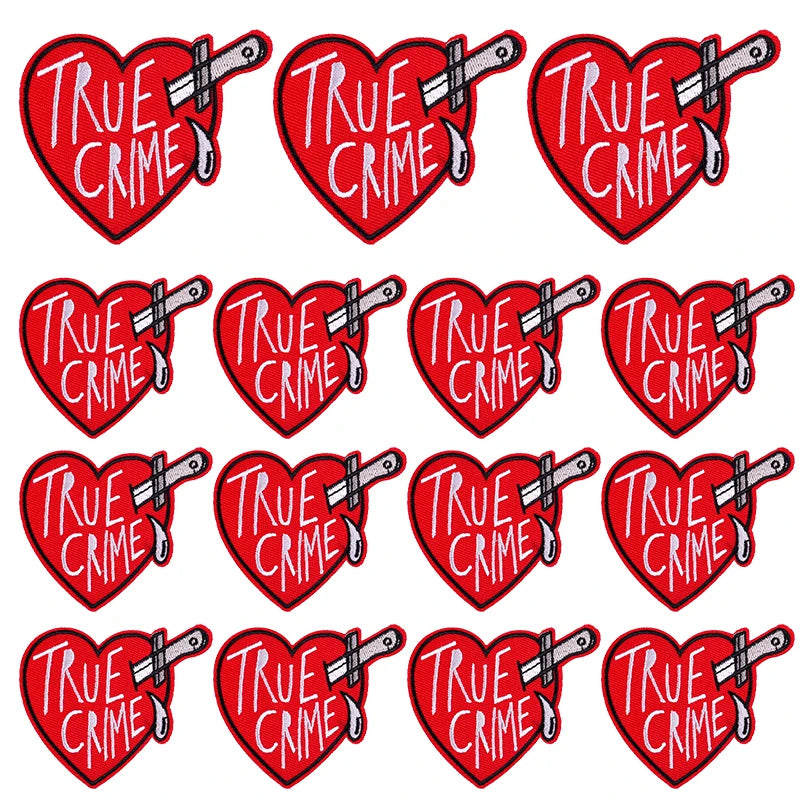 A set of ten red heart-shaped embroidered patches with the text TRUE CRIME and a silver knife design.