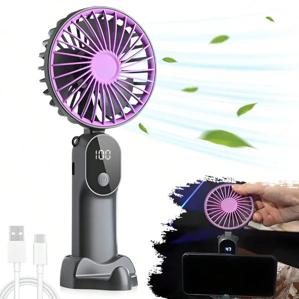 Schwarzer Handventilator mit lila Klinge und LED-Anzeige bläst Luft auf grüne Blätter.