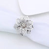 Silver decorative metal napkin rings featuring a detailed flower pattern