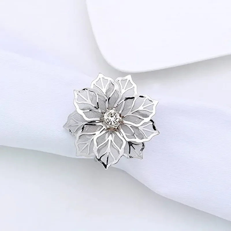 Silver decorative metal napkin rings featuring a detailed flower pattern