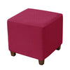 A square ottoman slipcover in a deep magenta color with a textured diamond pattern.