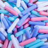 A pile of colorful, translucent plastic ball pit balls in various shades of blue, pink, and white.