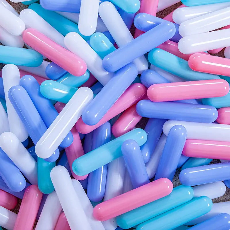 A pile of colorful, translucent plastic ball pit balls in various shades of blue, pink, and white.