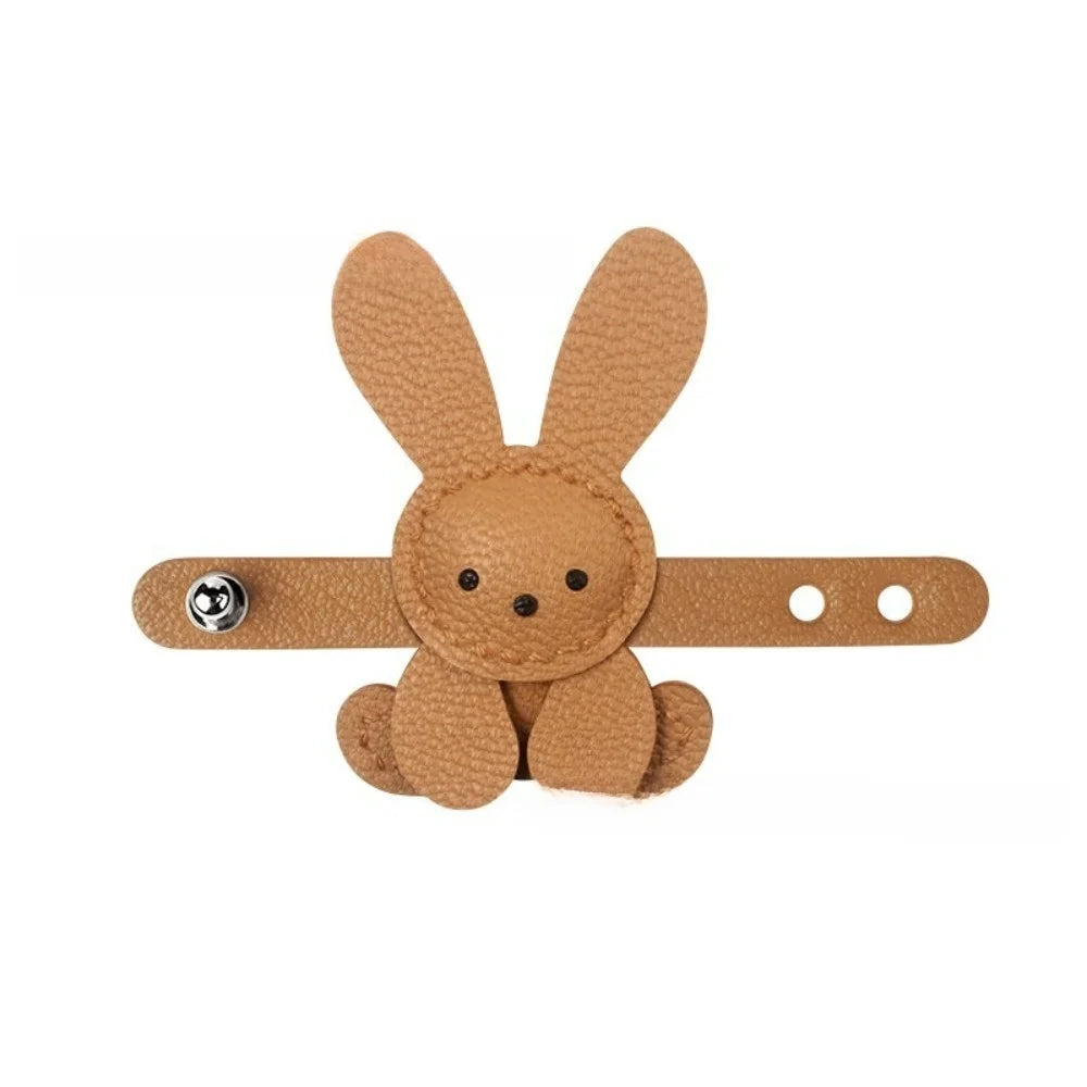 A tan felt bunny shape used as a bag charm or keychain.