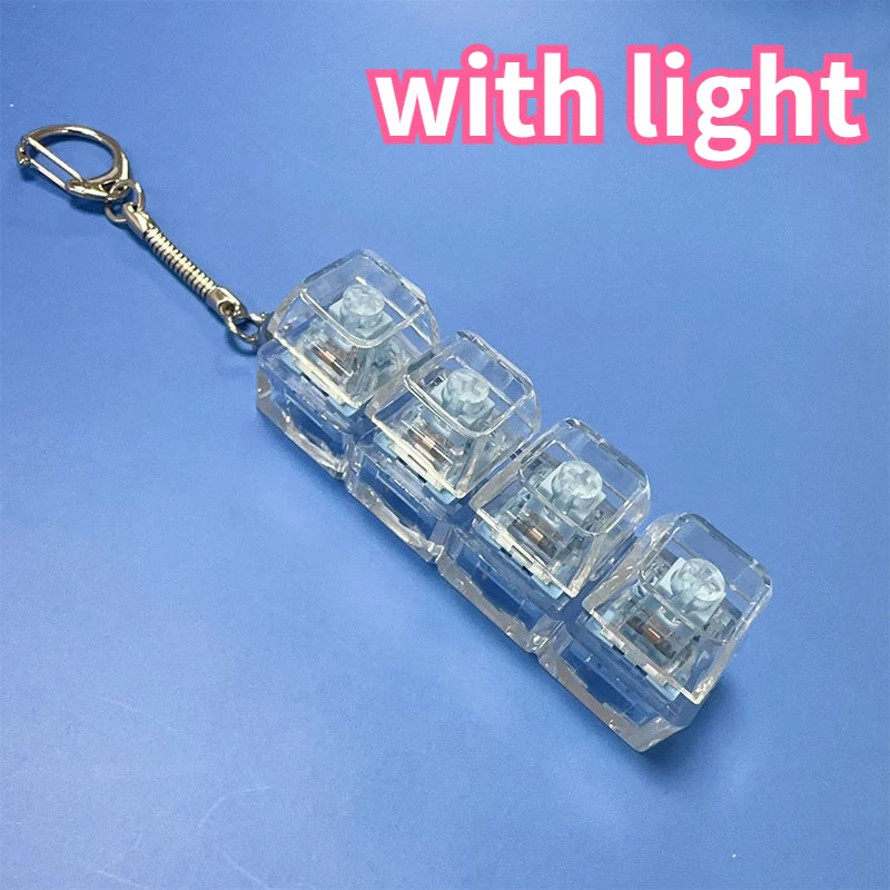 A clear acrylic LED mechanical keychain fidget toy with custom keycaps attached to a metal ring.