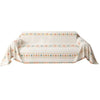 A beige bohemian jacquard sofa cover featuring geometric patterns in soft orange and teal tones.