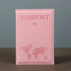 A pink leather passport holder featuring a faint world map design and embossed text.