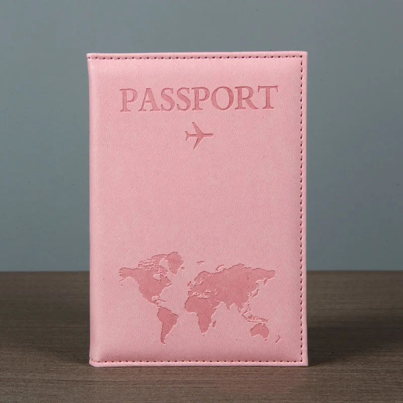 A pink leather passport holder featuring a faint world map design and embossed text.