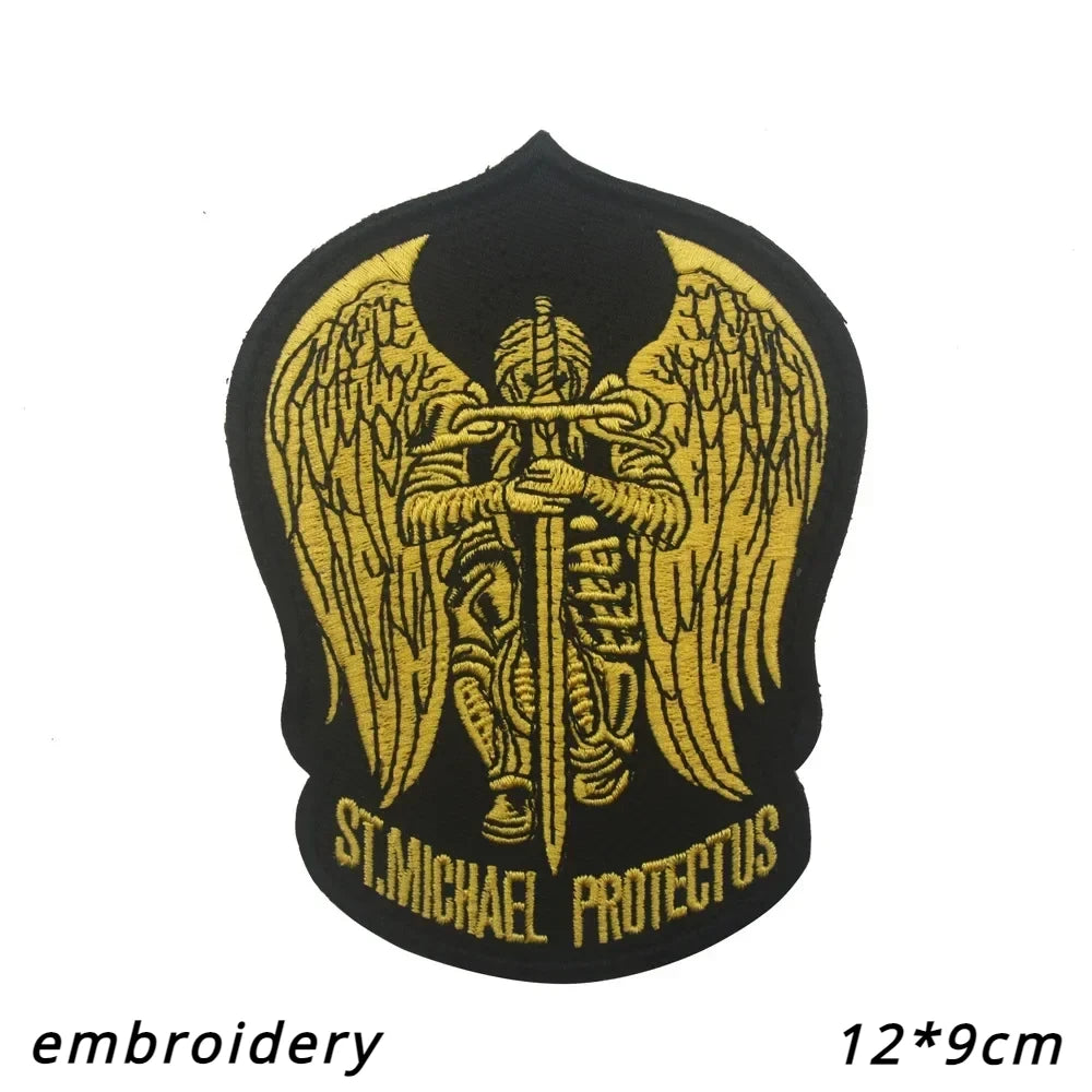 Black embroidered patch featuring a golden winged archangel St. Michael with text below