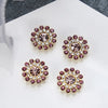 Four clusters of multicolor pink and gold rhinestone flowers on a white background.