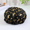 Black reusable elastic shower cap patterned with gold animal silhouettes