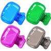 A set of four portable toothbrush head covers in blue, green, pink, and gray with clips.
