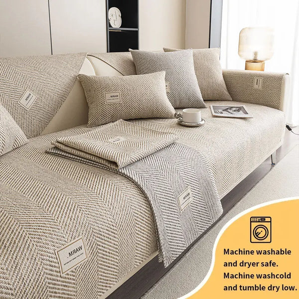 Coussin de canapé beige texturé avec une couverture assortie et des coussins décoratifs.