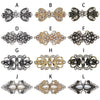 A collection of twelve vintage swirl metal clips in silver and gold tones for decorating cardigans and shawls