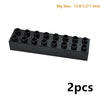 A black set of large building blocks or connectors with multiple cylindrical pieces.