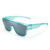 A pair of teal polarized clip-on sunglasses with a gray lens resting on a white background.