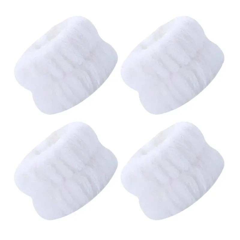 Four white absorbent microfiber wrist washing bands or face-saving cuffs.