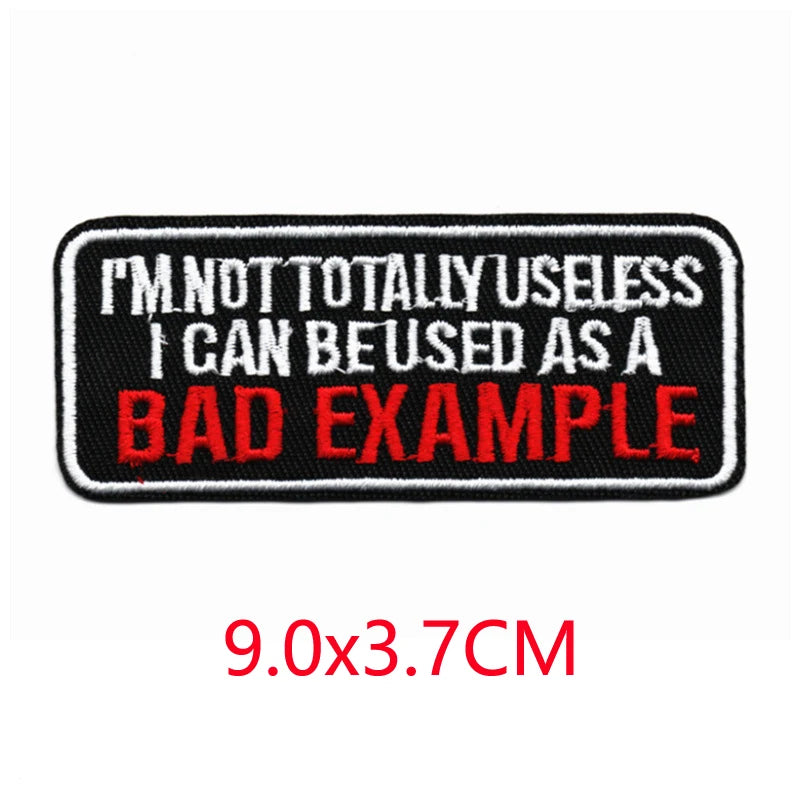 Black embroidered iron-on letter patch with red text that reads I'M NOT TOTALLY USELESS I CAN BE USED AS A BAD EXAMPLE