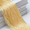 A bundle of golden beaded thread used for a curtain or room divider is displayed next to its packaging box.