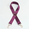 A purple nylon bag strap with a gold buckle shown diagonally.