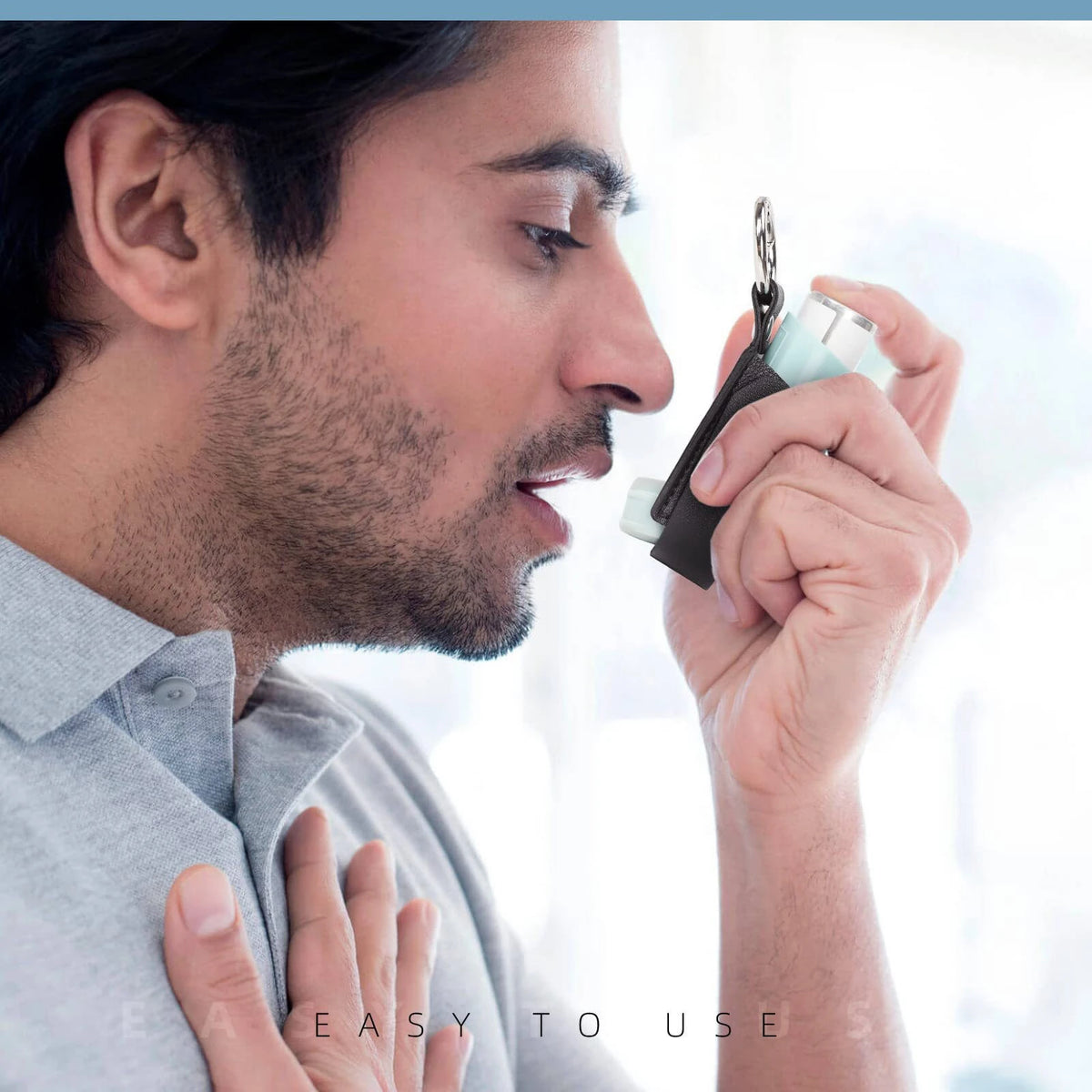 A man is holding a protective PU leather inhaler case with a keychain, demonstrating its use.
