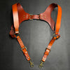 A pair of genuine brown leather double shoulder suspenders with brass hardware.