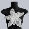 Silver floral lace applique patch with intricate sequins displayed on a black mannequin