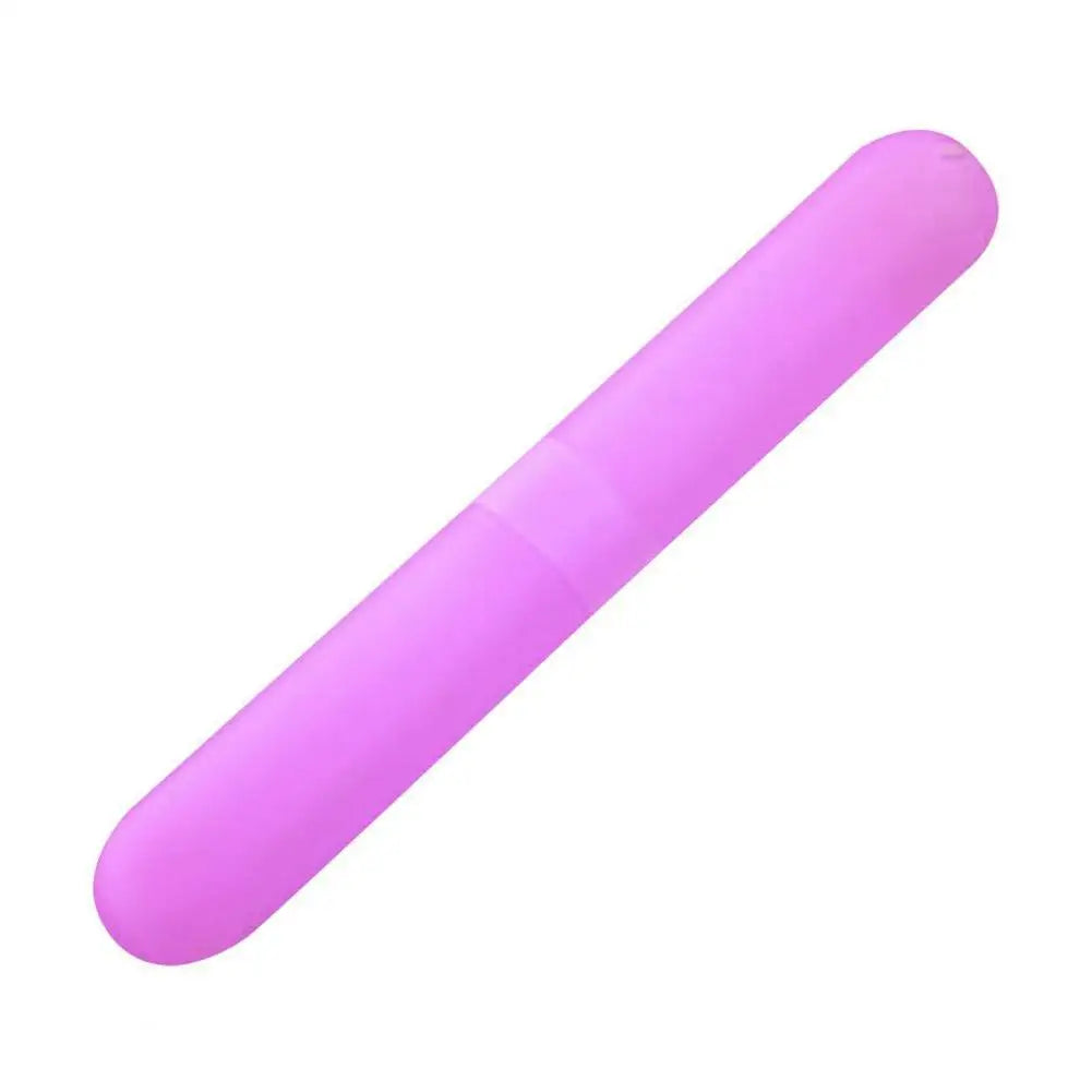 A pink portable toothbrush travel case with a smooth, elongated design.