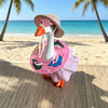 A ceramic goose wearing a pink sun hat and sunglasses with a ruffled beach outfit
